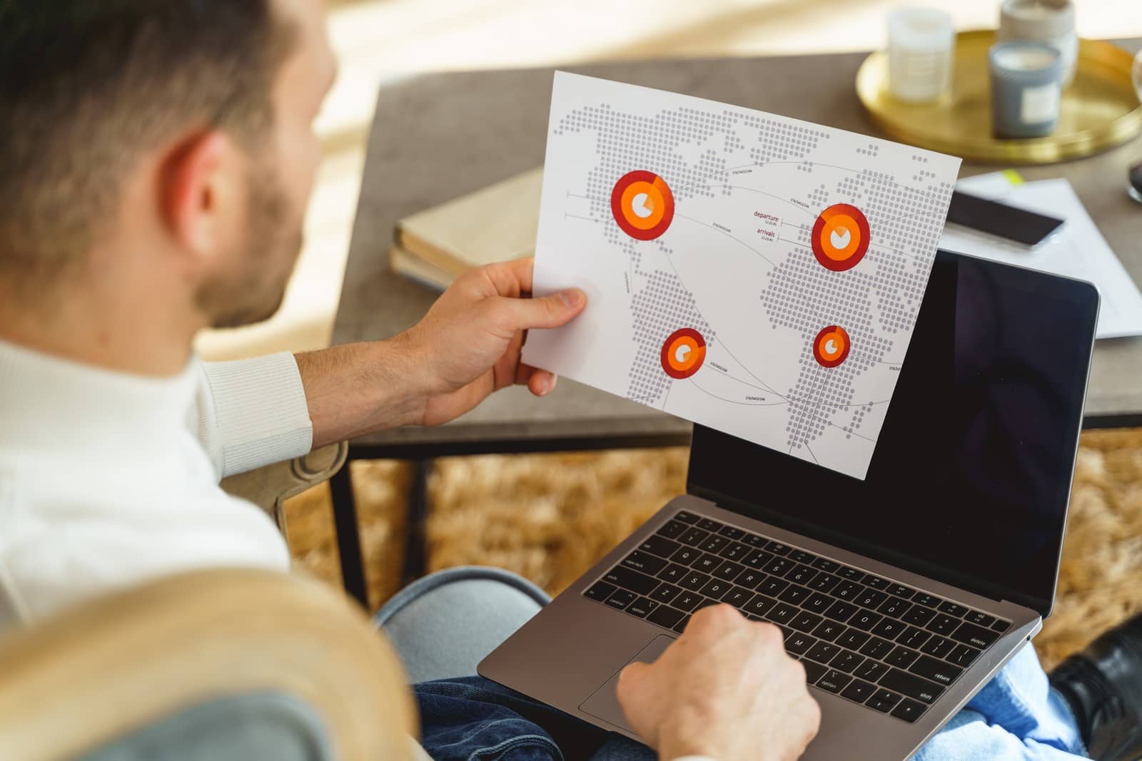 back-view-flight-dispatcher-with-laptop-his-knees-planning-flight-paths(1)