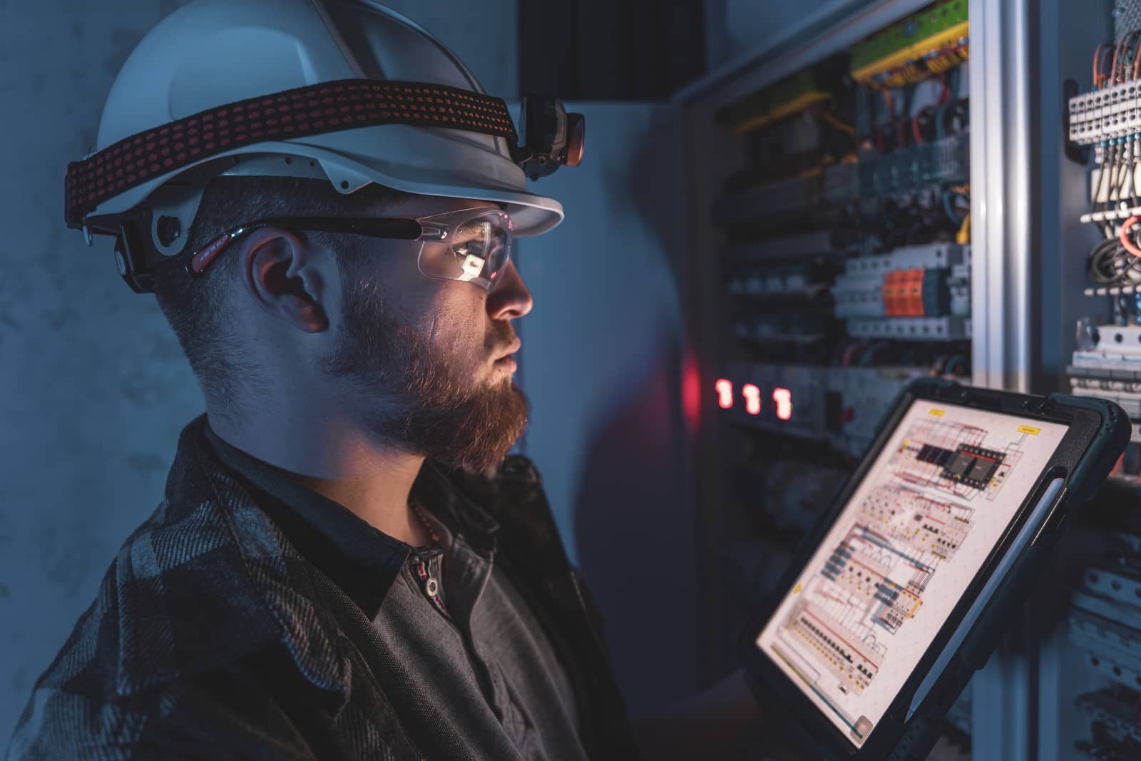 electrician-overalls-focused-work-switchboard-with-fuses-using-tablet(1)